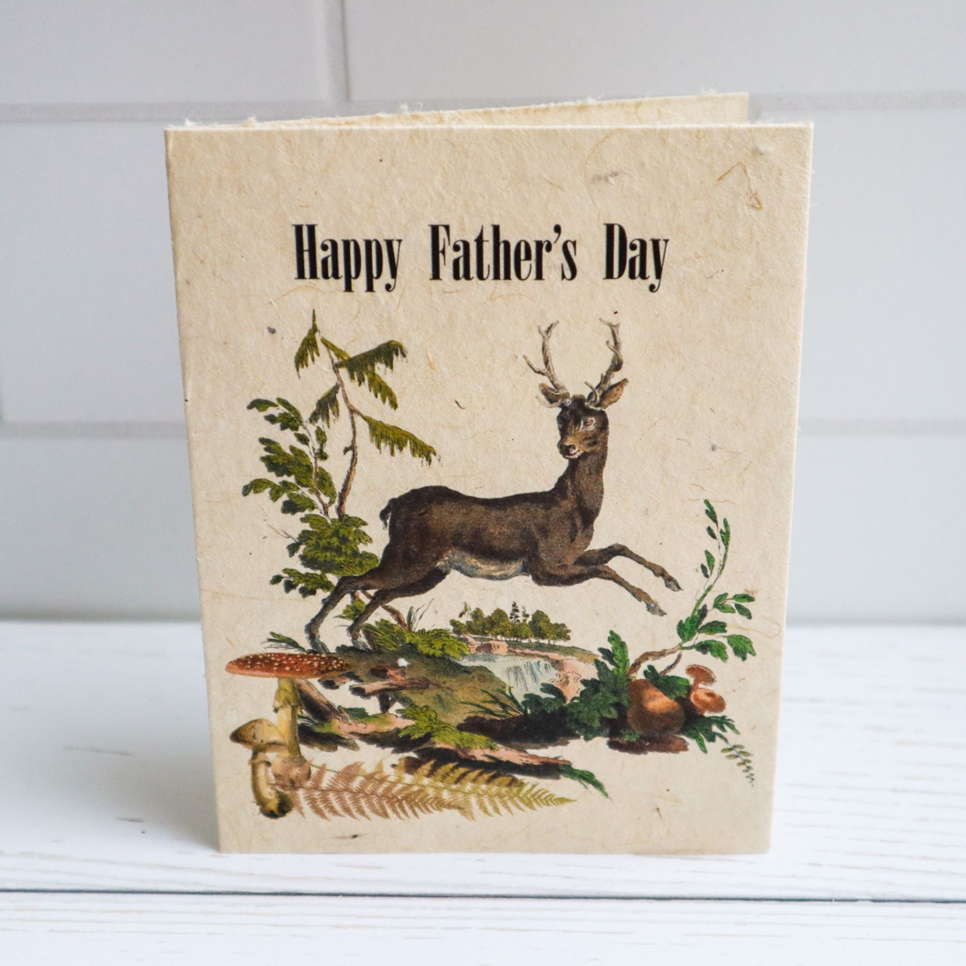 Happy Father's Day plantable flower seed paper card by Helen Jeanne Handmade with deer jumping, mushrooms, and river landscape
