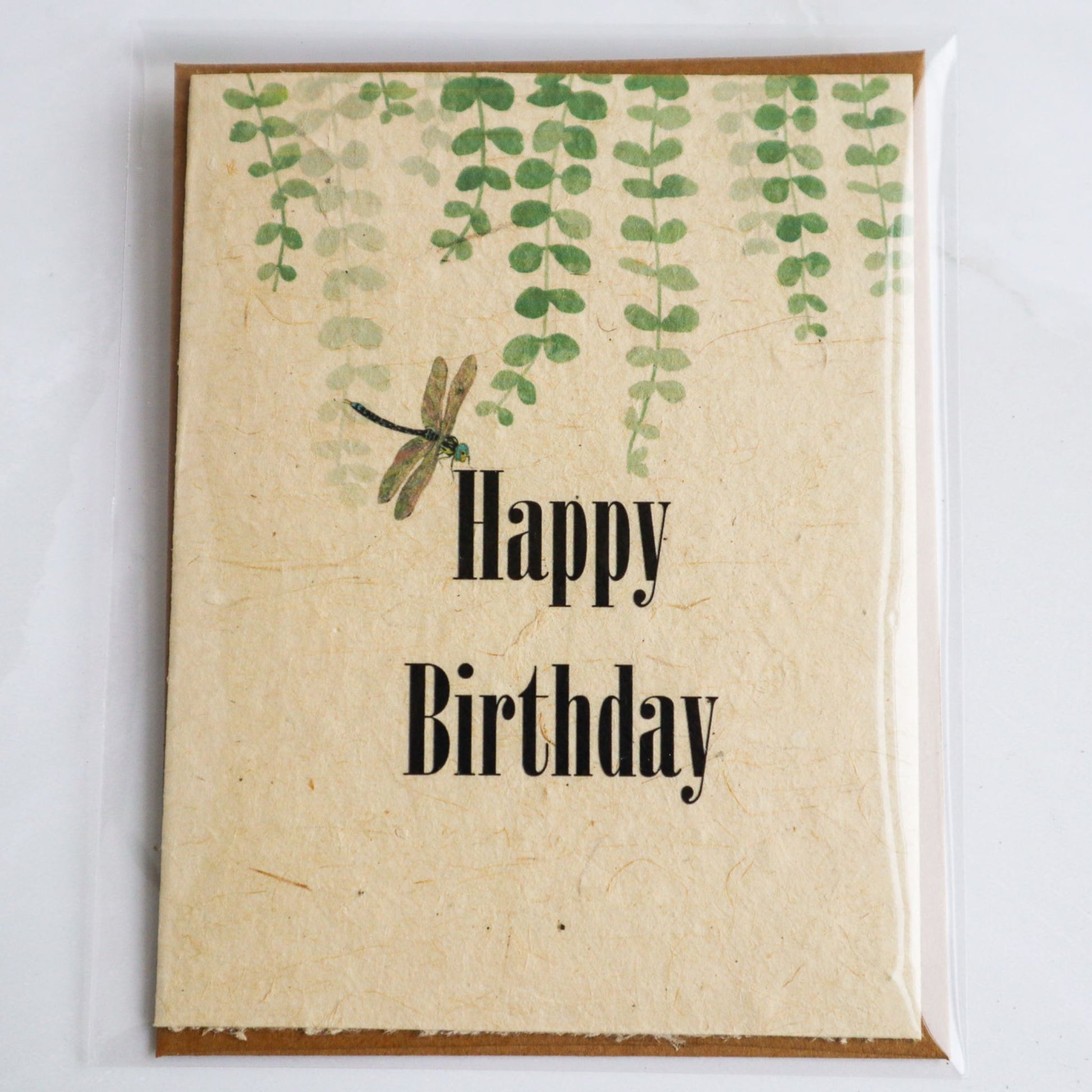 Plantable seed paper birthday card with dragonfly and greenery. Card is in biodegradable sleeve with kraft envelope.